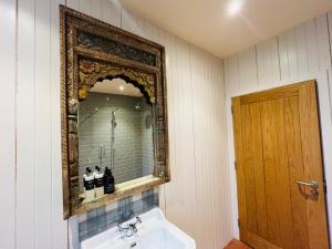 a bathroom with a mirror and a sink at Black Isle Bar Apartment in Fort William +17 photos
