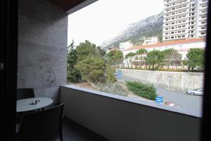 a balcony with a table and a view of a city at Dion Boutique Hotel - City Center in Krujë +19 photos