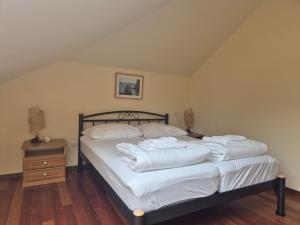 a bedroom with a bed with white towels on it at Modern new flat next to river Cetina in Omiš