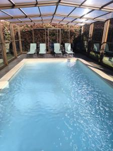 a large swimming pool with chairs at Casa de Reborido in Ponte da Barca