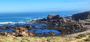 a view of the ocean from the top of a mountain at Lighthouse Studio in Doring Bay +4 photos