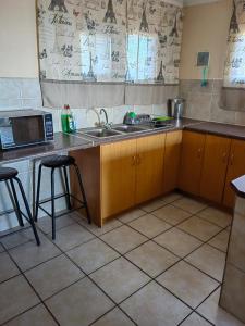a kitchen with a sink and a microwave at Lighthouse Studio in Doring Bay