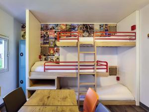 a room with two bunk beds and a table at hotelF1 Crosne Créteil in Crosne