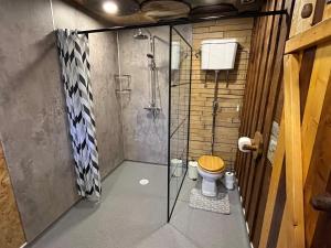 a bathroom with a shower with a wooden toilet at The Bothy Aberlour in Aberlour