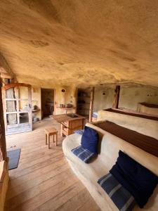 a large room with two beds and a table at Maison Terre Les Cabanes de Fallot - sauna bain-froid piscine naturelle in LʼIsle-Bouzon +8 photos