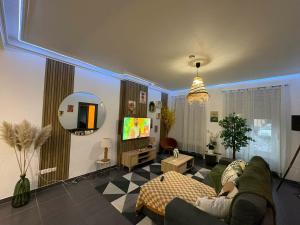 a living room with a couch and a tv at La Dryade in Braux