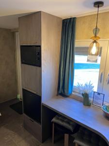 a kitchen with a desk and a window at Venus Casa in Solt