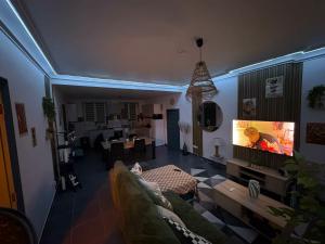 a living room with a couch and a tv at La Dryade in Braux