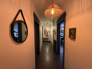 a hallway with a mirror on the wall and a hallway sidx sidx sidx at La Dryade in Braux