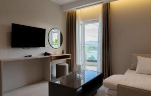 a hotel room with a bed and a tv and a window at Hotel Leon in Debar