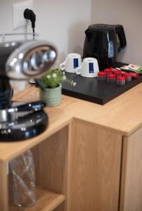 a counter top with a coffee maker on it at Hotel Leon in Debar