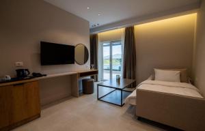 a hotel room with a bed and a flat screen tv at Hotel Leon in Debar +39 photos
