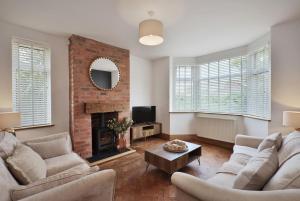 a living room with two couches and a fireplace at Spacious Gate 3BR City 5mins Walk Pets Welcome in Hereford