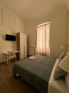 a bedroom with a bed and a table and a window at Mare guest house in Termoli
