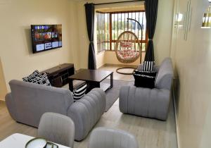 a living room with two couches and a table at Nivaro Homes in Nakuru