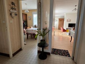a hallway with a living room and a dining room at Maison ALCEMA in Carentan