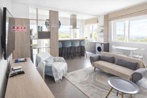 a living room with a couch and a table at RayGrass, La Gaulette in La Gaulette +1 photo