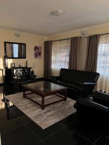 a living room with a couch and a coffee table at Indolo Home in Bulawayo