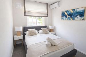 a bedroom with two beds and a window at RayGrass, La Gaulette in La Gaulette