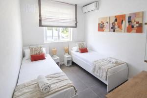 a bedroom with two beds and a window at RayGrass, La Gaulette in La Gaulette