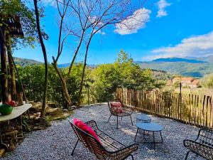 a patio with chairs and a table with a view at Housica & Co 2 in Ucciani +30 photos