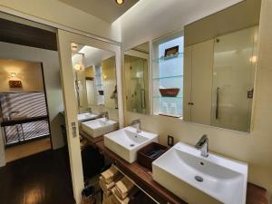 a bathroom with two sinks and two mirrors at Private Villas Ryuz備瀬 in Motobu +75 photos