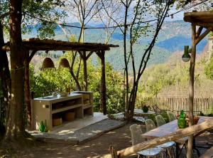 a patio with a table and chairs and a tree at Housica & Co 2 in Ucciani