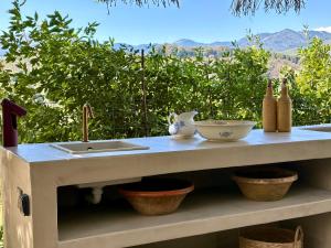 a kitchen counter with a sink and bowls on it at Housica & Co 2 in Ucciani