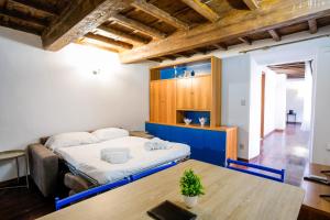 a room with a bed and a wooden table at Drago D'oro Boutique Apartment in Florence +30 photos