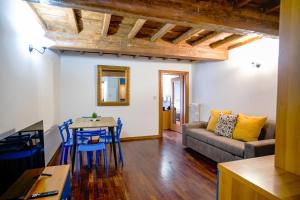 a living room with a couch and a table and chairs at Drago D'oro Boutique Apartment in Florence