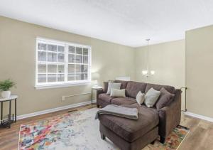 a living room with a couch and a window at Hillside Haven - affordable and convenient in Chattanooga +19 photos