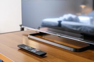 a remote control sitting on a table next to a tv at Drago D'oro Boutique Apartment in Florence