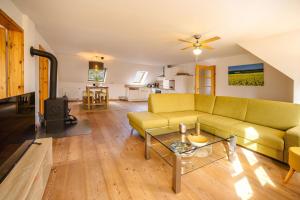 a living room with a couch and a table at Freya in Goltoft