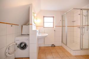 a bathroom with a washing machine and a sink at Freya in Goltoft +14 photos