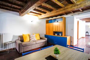 a living room with a couch and a table at Drago D'oro Boutique Apartment in Florence