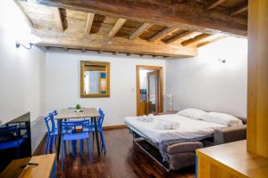 a bedroom with a bed and a table and chairs at Drago D'oro Boutique Apartment in Florence