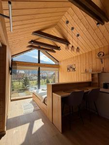 a kitchen with a table and a bed in a room at Nest house in Skole