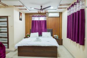 a bedroom with a large bed with purple curtains at X Western Hills panchagani in Panchgani +85 photos