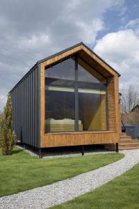 a house with a large window on the grass at Nest house in Skole