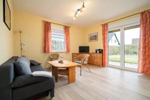 a living room with a couch and a table at Ferienwohnung Haus Vietzen 2 in Rechlin