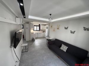 a living room with a couch and a kitchen at Erdem Apart D4 in Dalaman