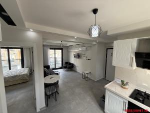 a living room with a bed and a kitchen with a table at Erdem Apart D4 in Dalaman +8 photos