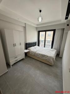 a bedroom with a bed and a large window at Erdem Apart D4 in Dalaman
