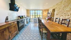 a kitchen with a large wooden table and chairs at Domaine de La Brave in Pernes-les-Fontaines