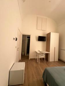 a room with a bed and a table and a desk at Mare guest house in Termoli
