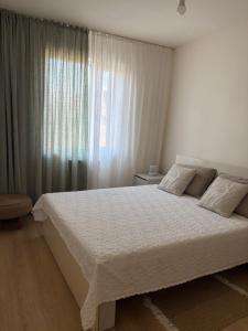 a bedroom with a large bed and a window at TREFOIL in Lori Berd