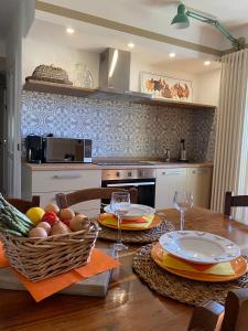 a kitchen with a wooden table with a basket of fruit at New IL RICCIO in Cernobbio