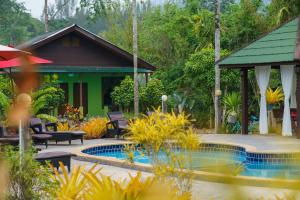 a resort with a swimming pool and a house at Ao Nang Baan Suan Resort in Ao Nang Beach