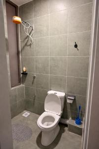 a bathroom with a toilet and a shower at The Cozy Cube at Tsavo Sunset in Nairobi