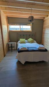 a bedroom with a bed in a room with a window at Finca Real in Negreira